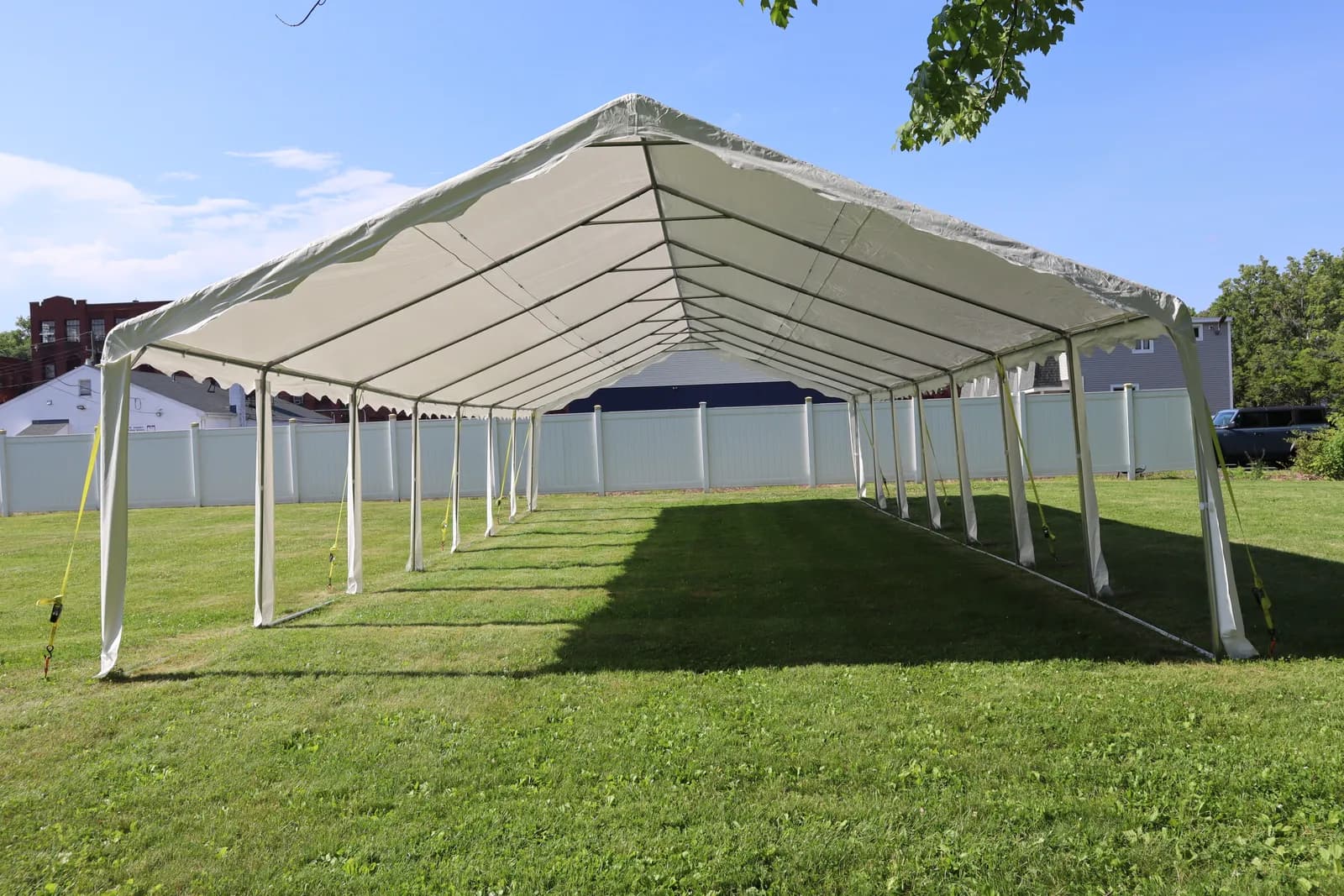 A large white event tent set up on the club grounds