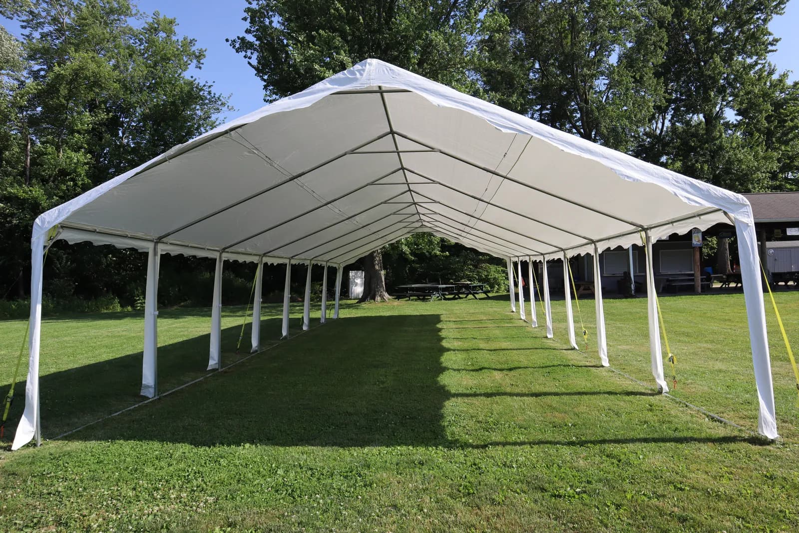 An open-sided event tent on the lawn